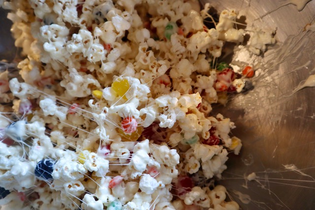 Mixing up popcorn cake in a bowl.