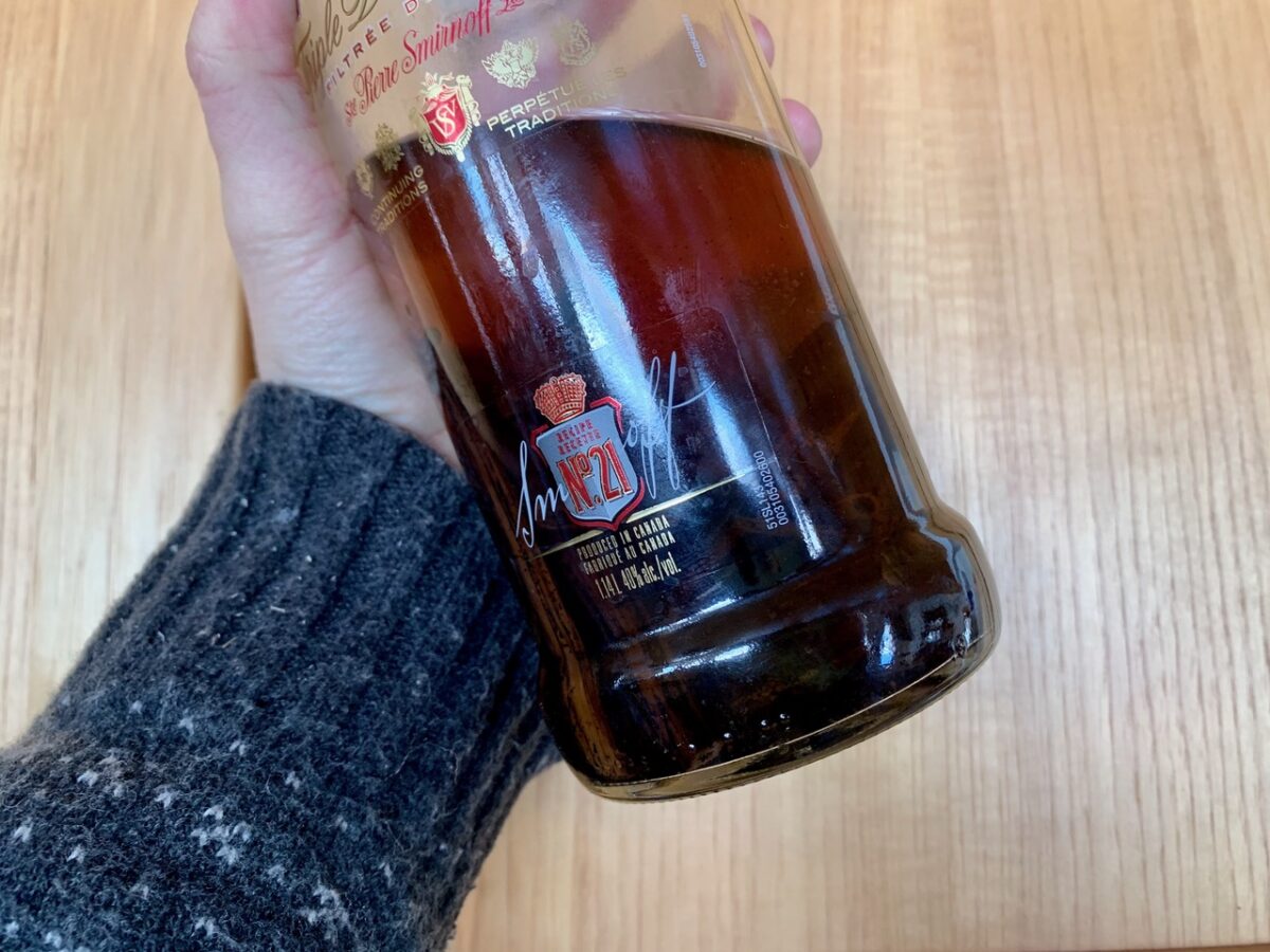 Homemade vanilla extract in a vodka bottle.