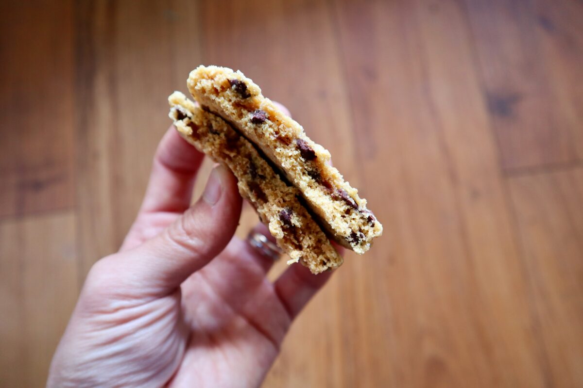 Chocolate chip cookies broken in half to show the interior texture.