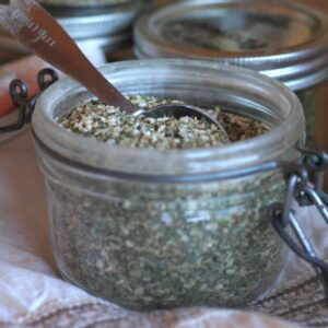 A flip top jar filled with homemade ranch seasoning.