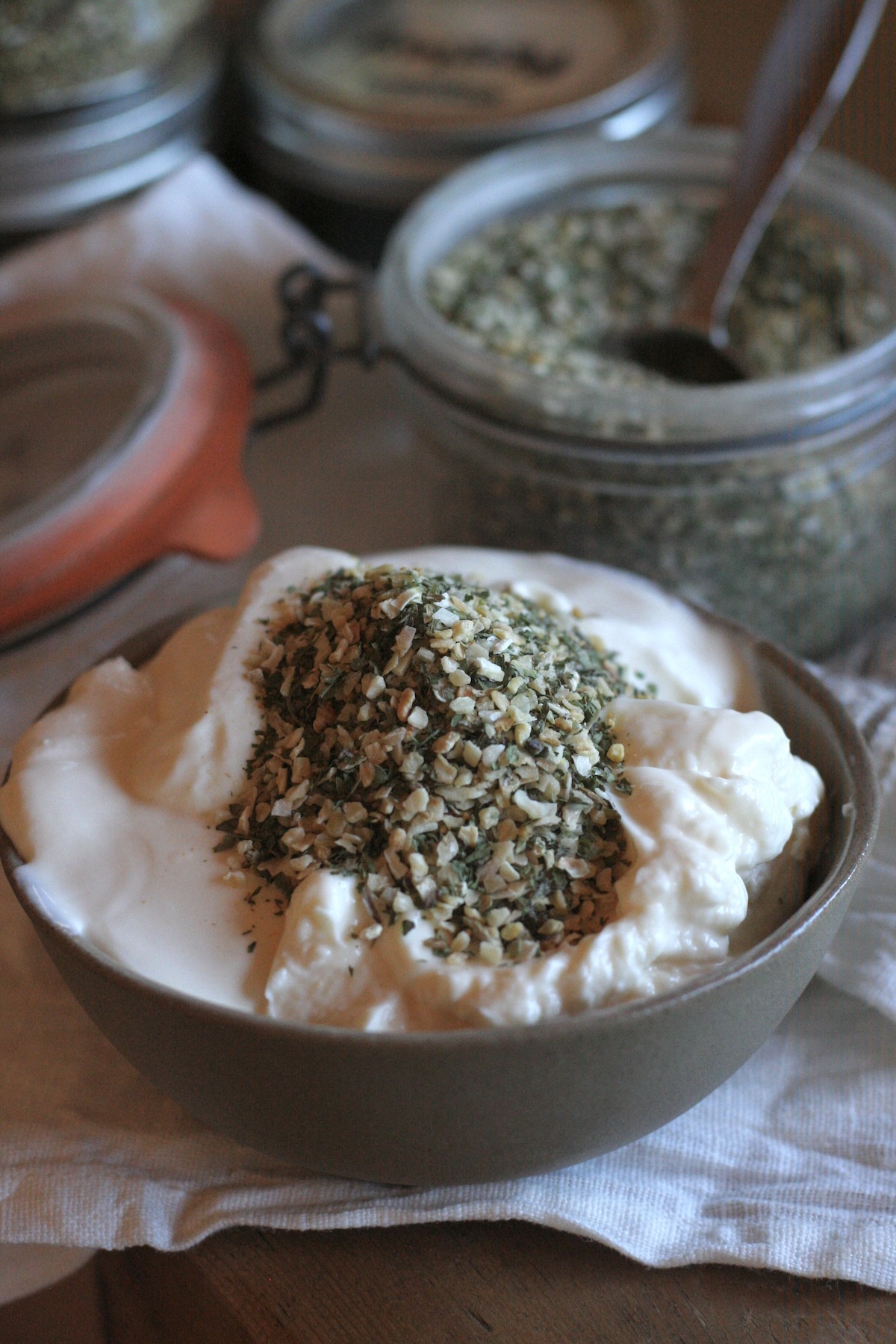 A pile of ranch seasoning in a bowl of sour cream to make dip.