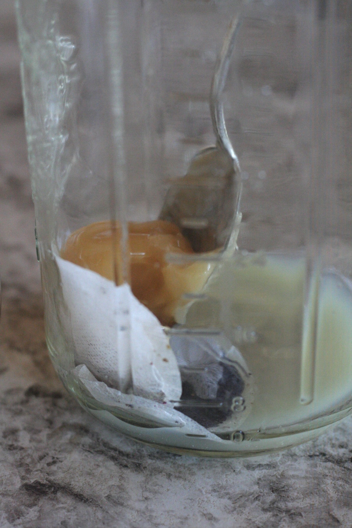 Three tea bags with lemon juice and honey in a large jar.