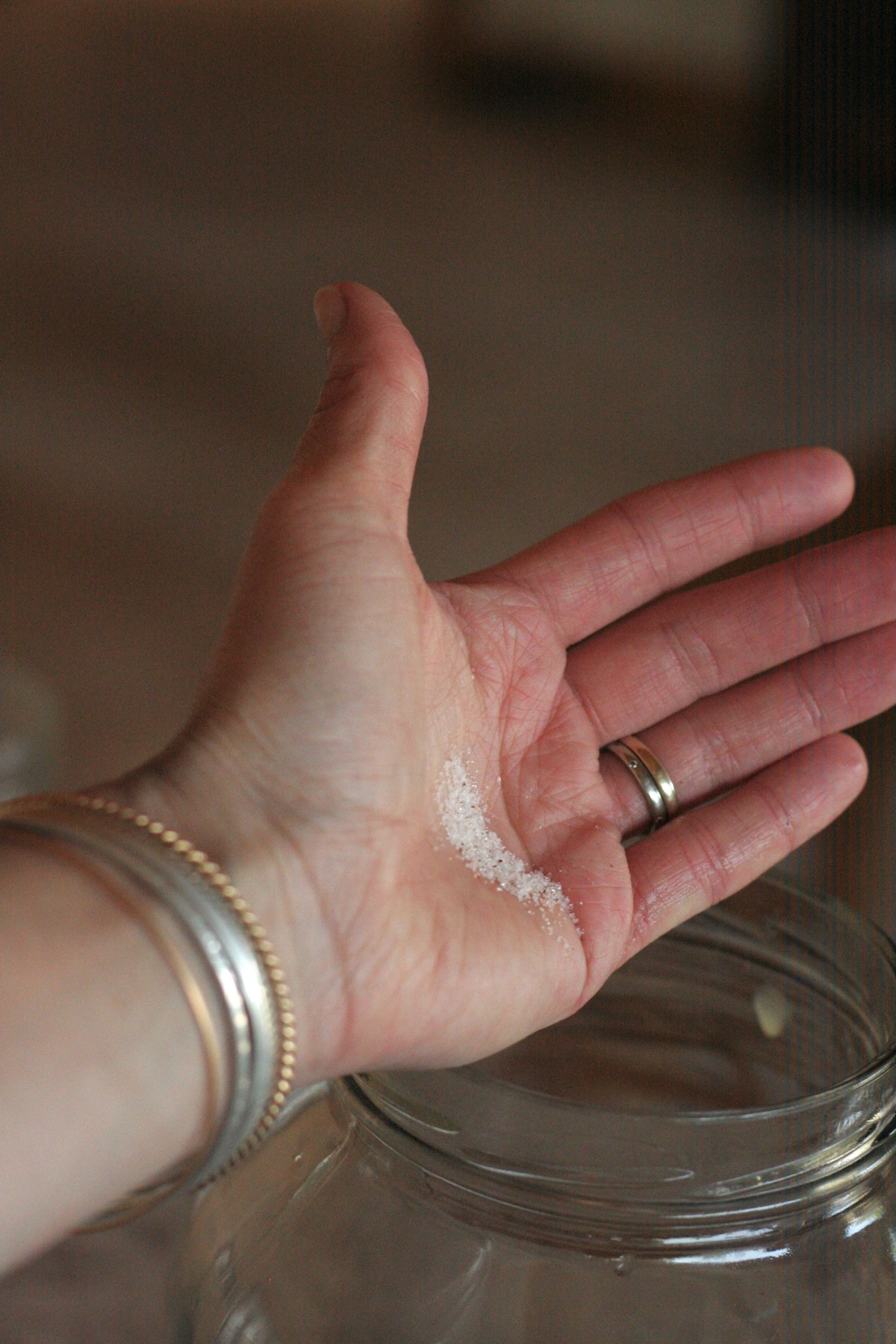 Woman's hand showing a teaspoon of salt.