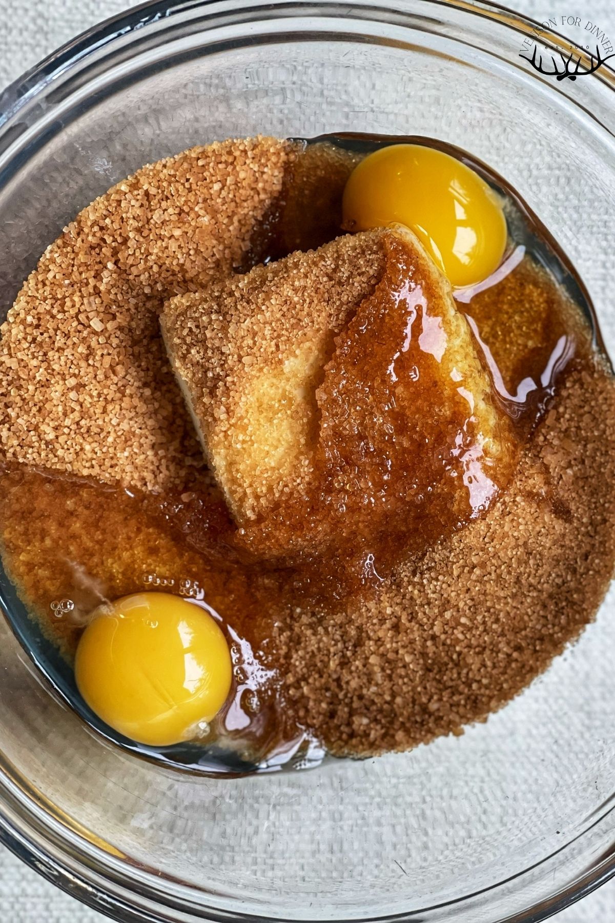 Butter, coconut sugar, and eggs in a glass mixing bowl.