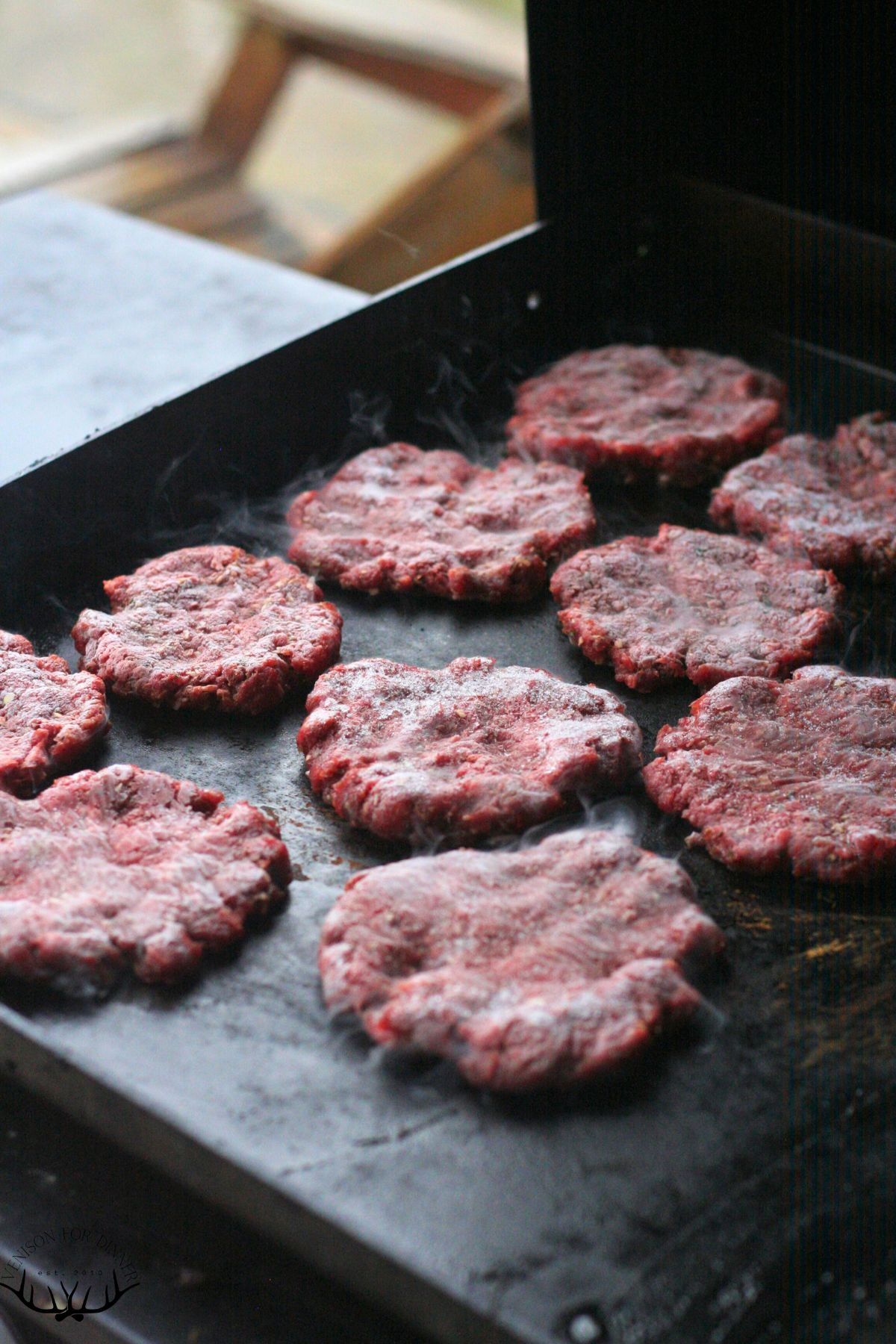 Freshly formed moose patties on a Blackstone.