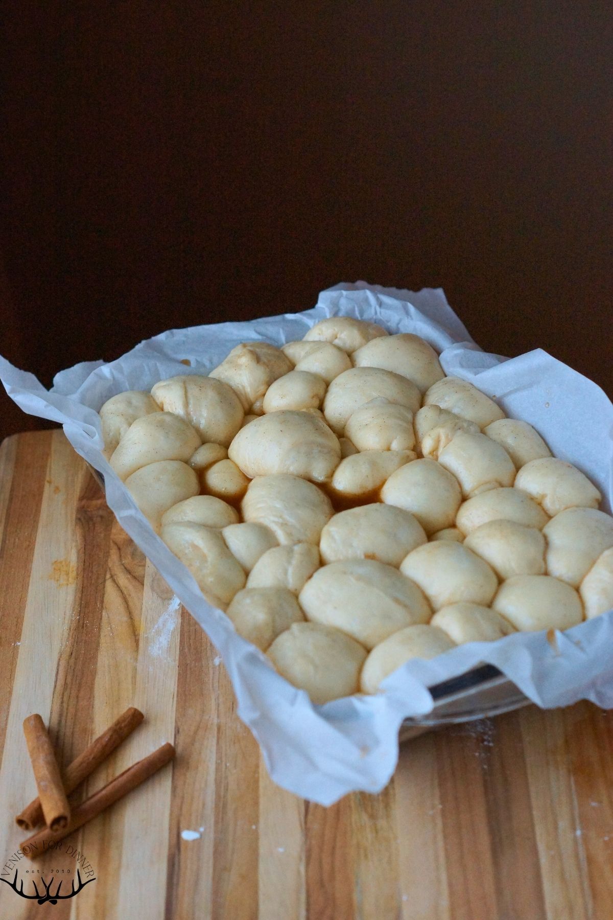 Dough balls proofing in a baking dish.