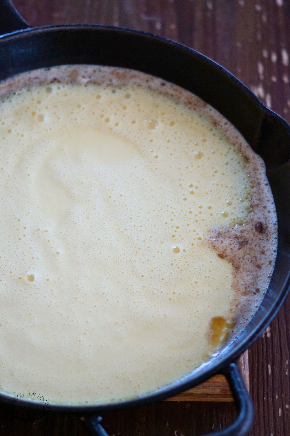 Pancake batter poured in a hot cast iron skillet.