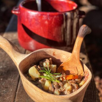 Venison stew in a small wooden bowl.