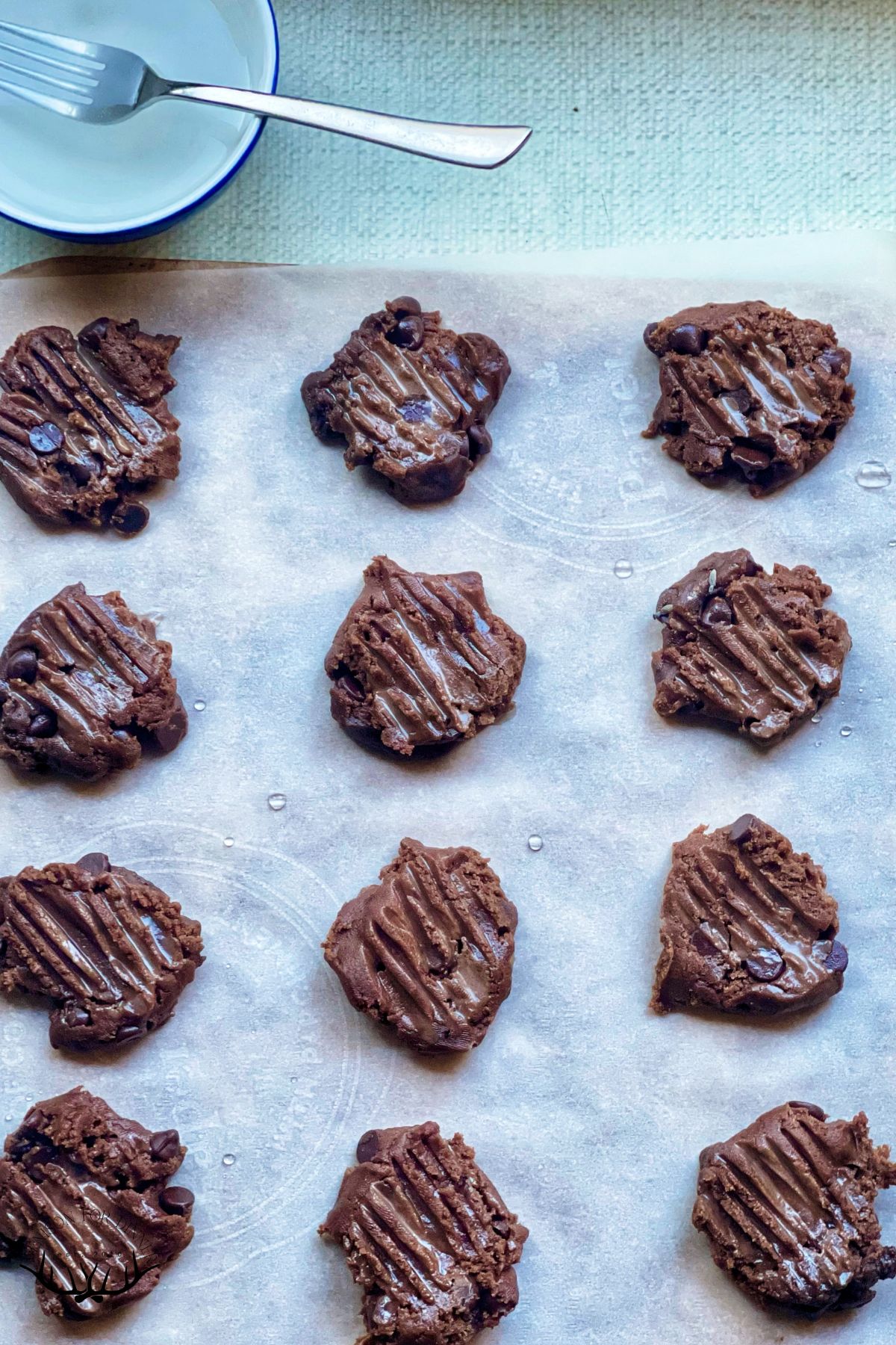 Pressed vegan cookies on parchment paper.