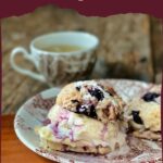 Baked blueberry scones on a china plate.