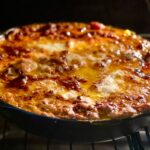 Lasagna in a cast iron skillet.