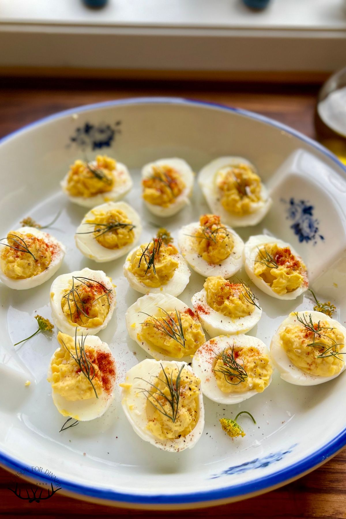 A platter full of angel eggs or deviled eggs.