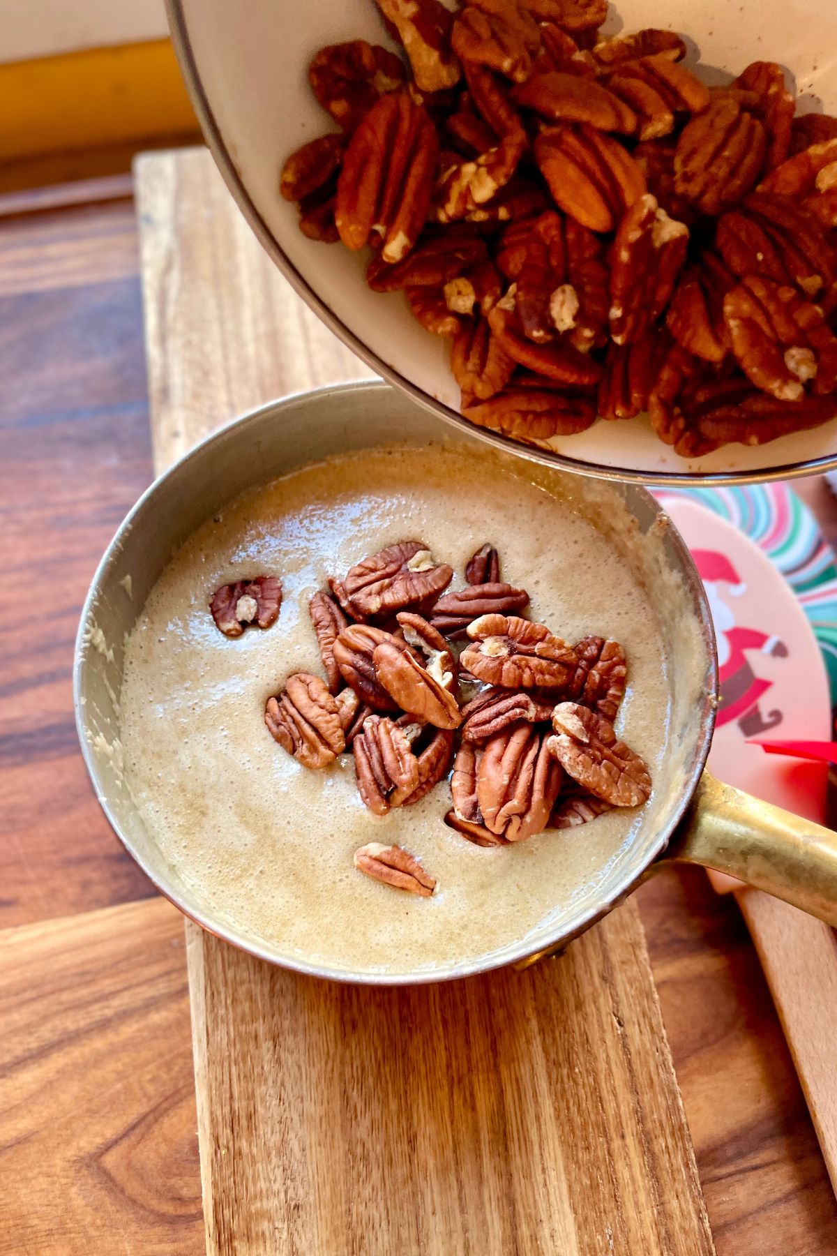 Adding pecans to hot caramel.