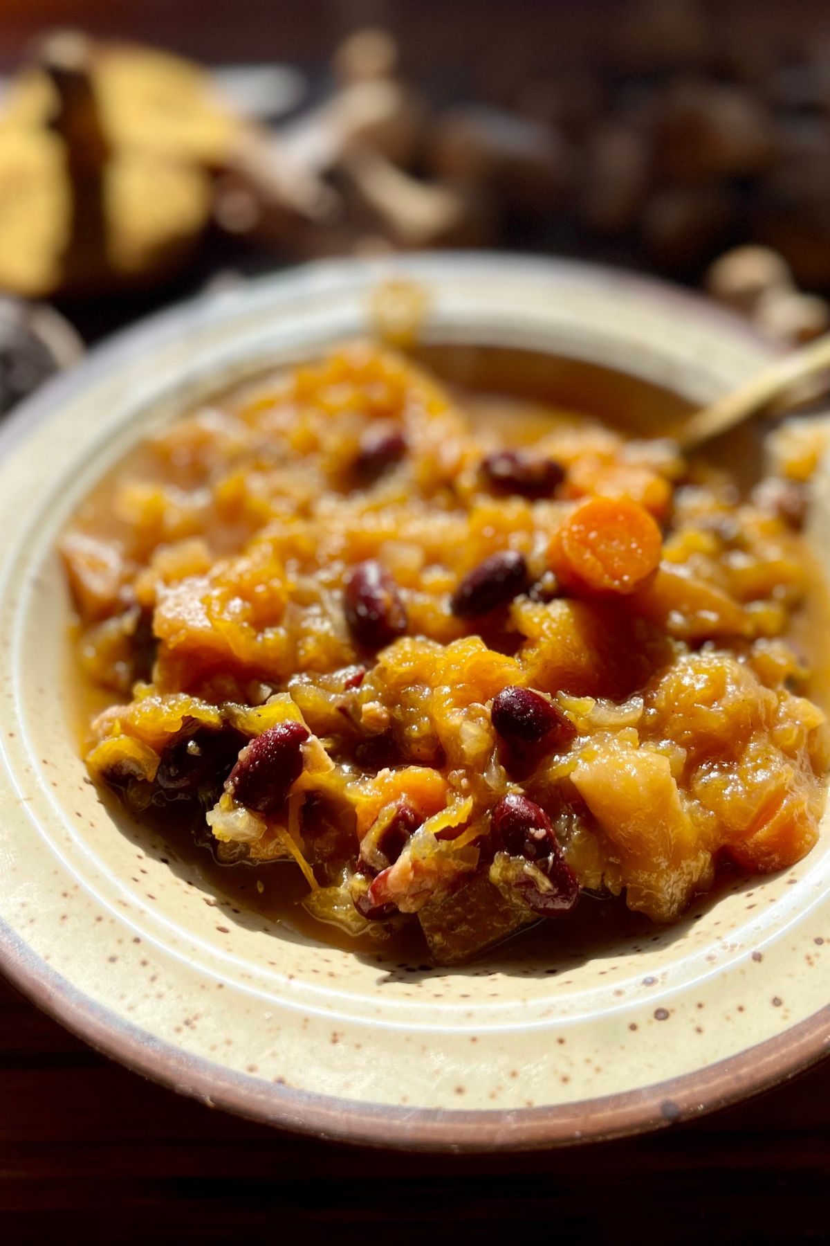 A bowl of pumpkin soup with beans.