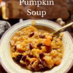 A bowl of pumpkin soup with beans.