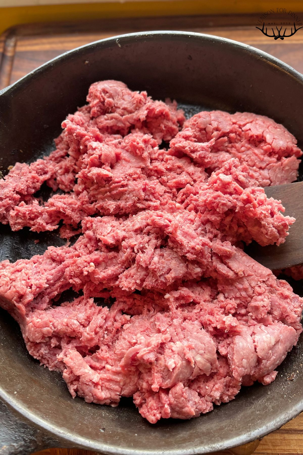 Pound of ground venison in a skillet.