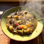 A steaming bowl of venison vegetable soup.