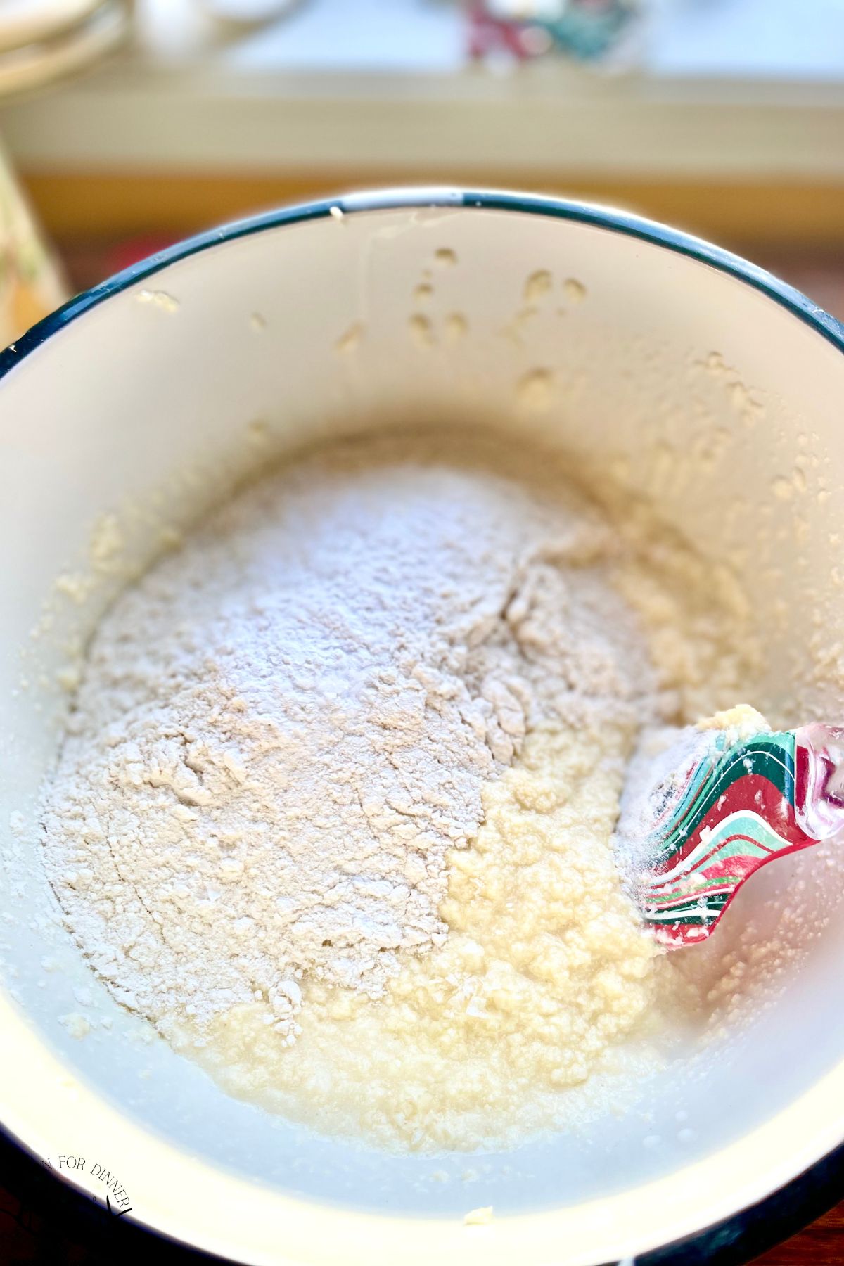 Flour added to wet cake ingredients.