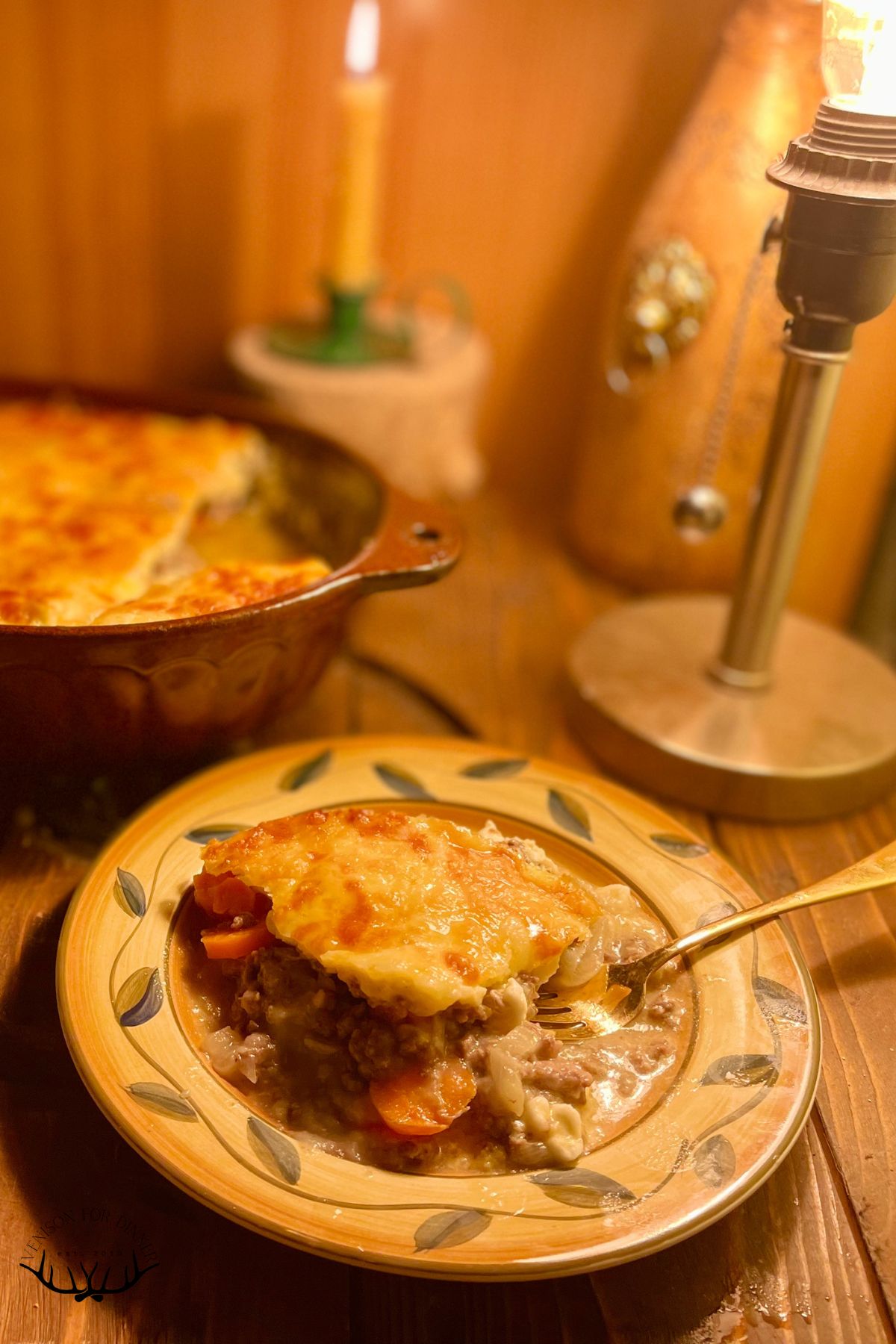 Slice of cheese-topped venison casserole.