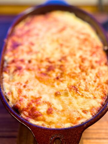 Cheesy topped venison casserole in a baking dish.