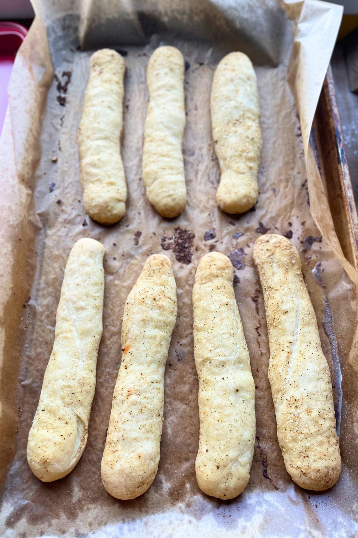 Baked sourdough breadsticks coated with garlic butter.