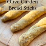 Olive Garden copycat sourdough breadsticks on a wooden board.