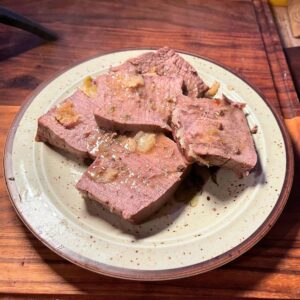 Garlic basted deer roast on a palte.