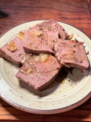 Garlic basted deer roast on a palte.