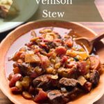 Large bowl of venison stew made in a dutch oven.