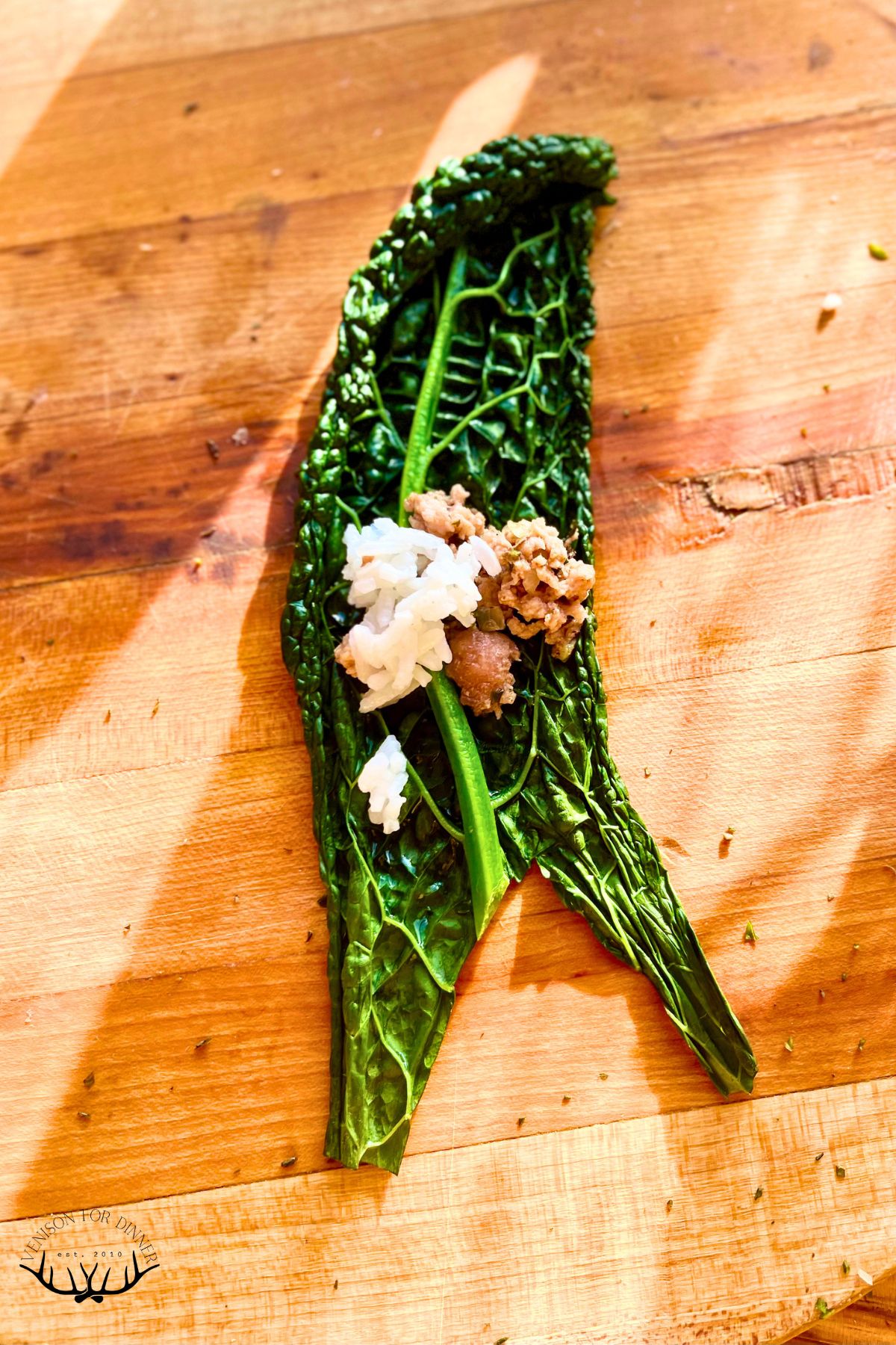 Pork filling on a kale leaf.