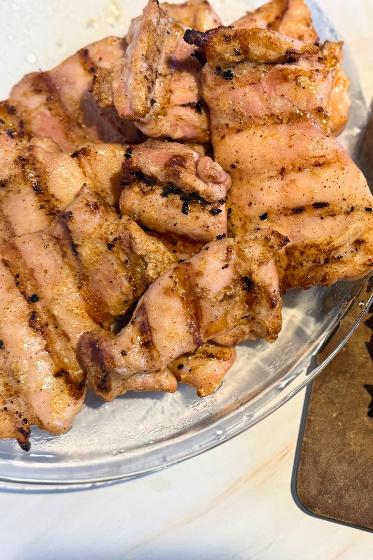 Grilled chicken thighs on a platter.