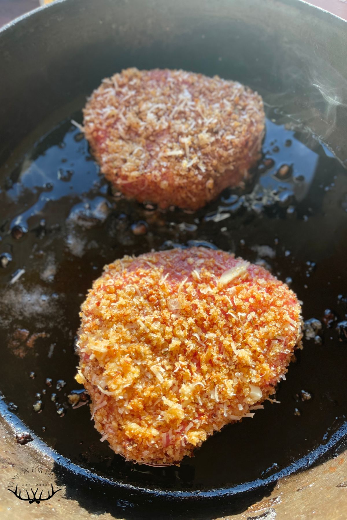 Pan frying venison cutlets.