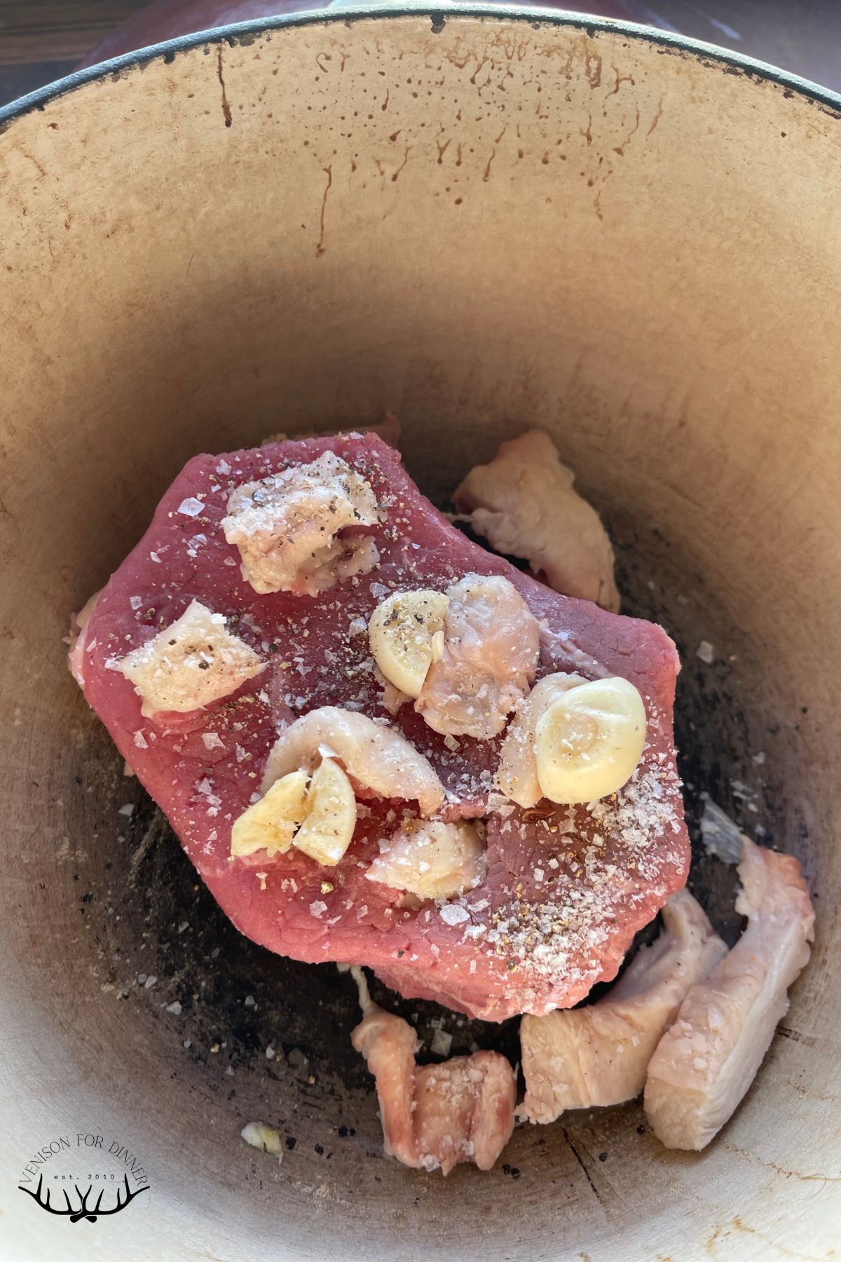 Garlic and fat tucked into a deer roast.