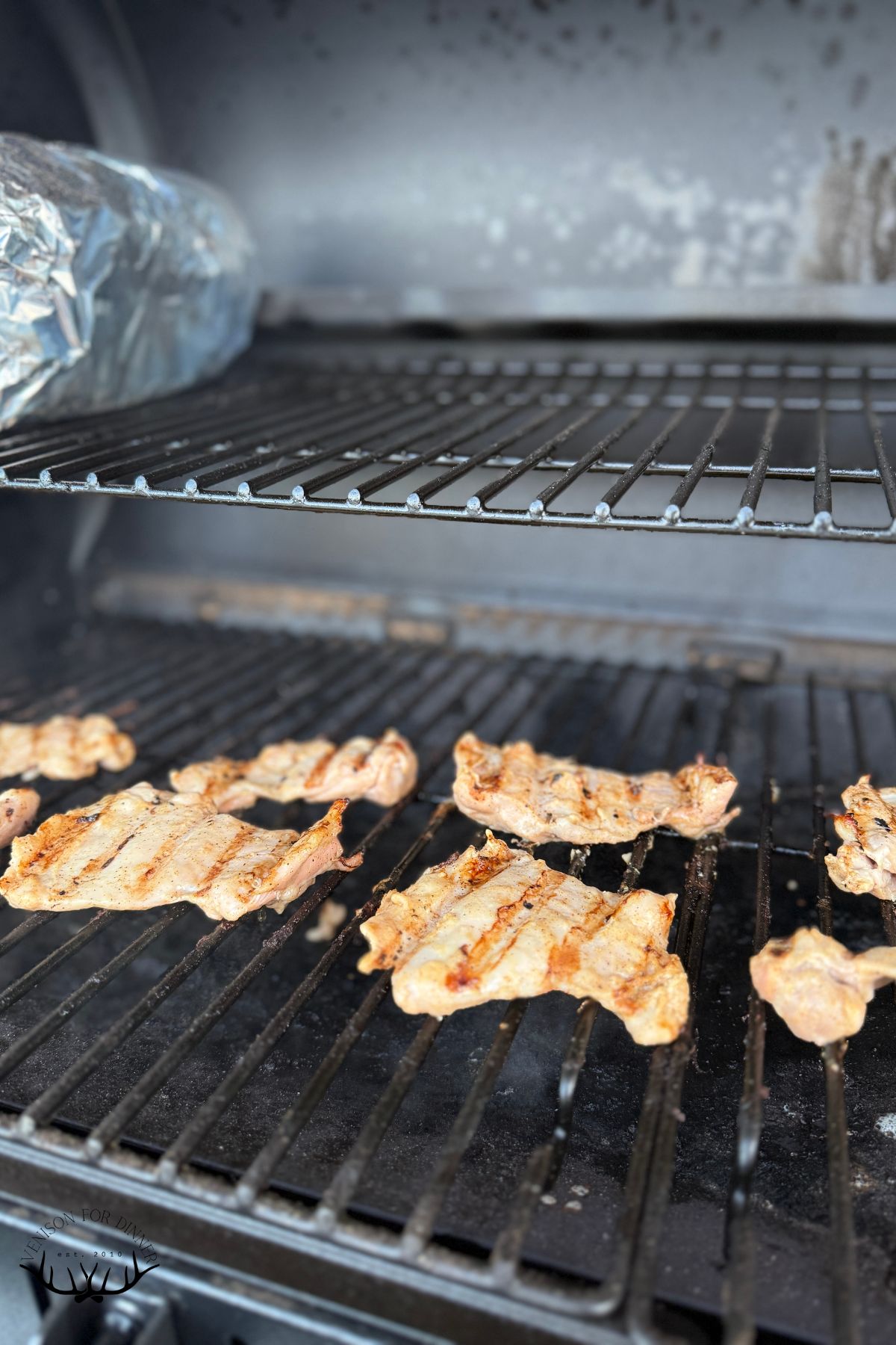 Flipped chicken thighs on pellet grill.