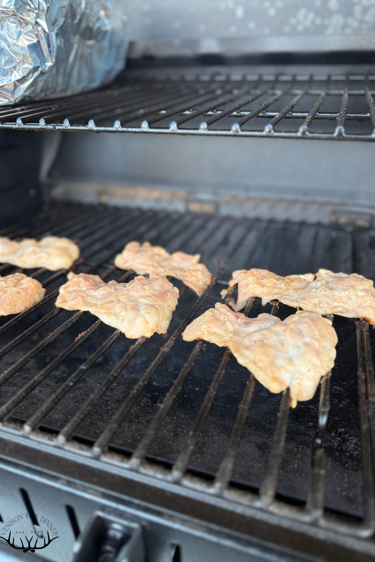Chicken thighs on a Traeger grill.