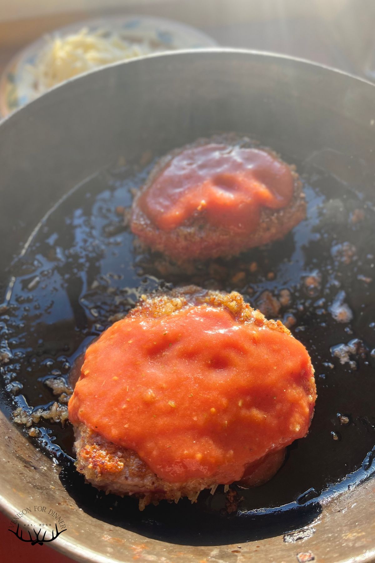 Tomato sauce over venison cutlets.
