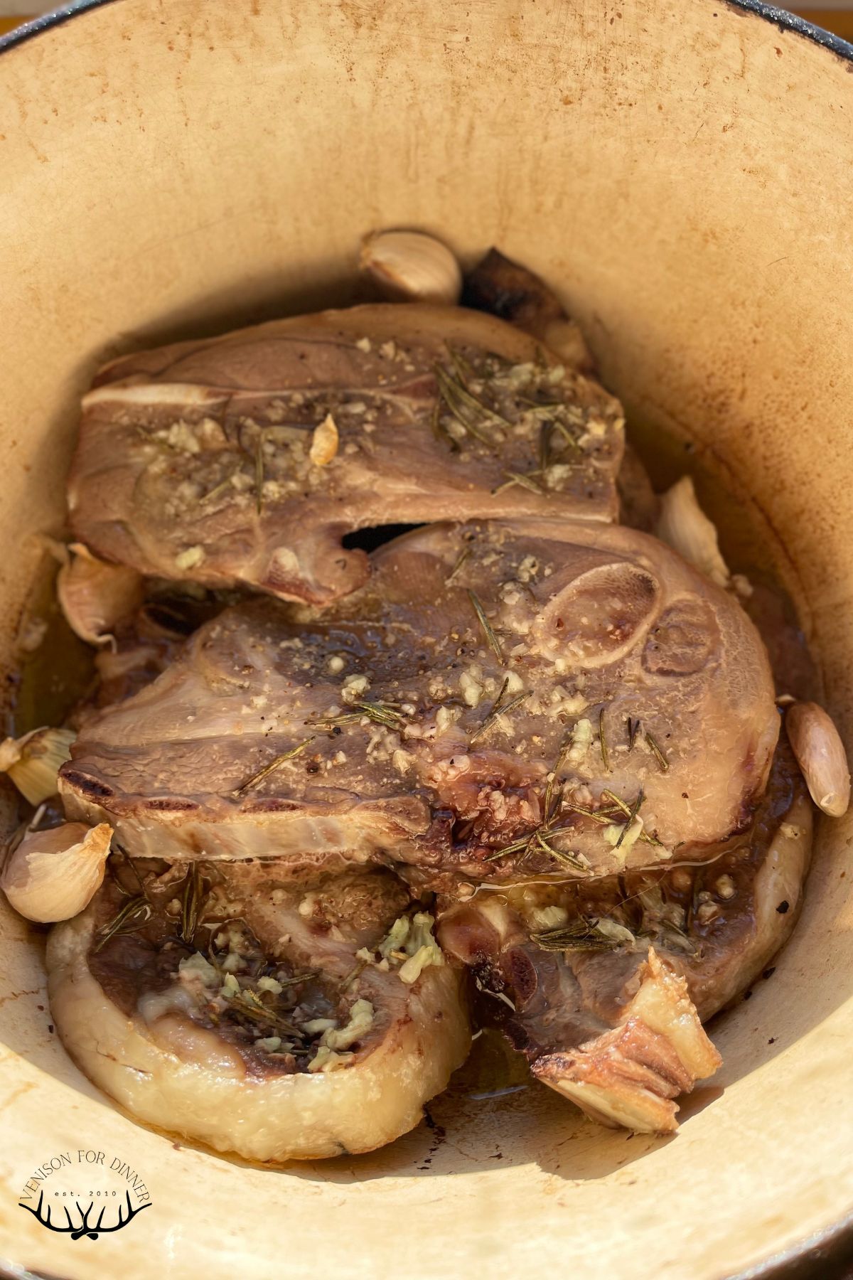 Roasted lamb chops in a Dutch oven.