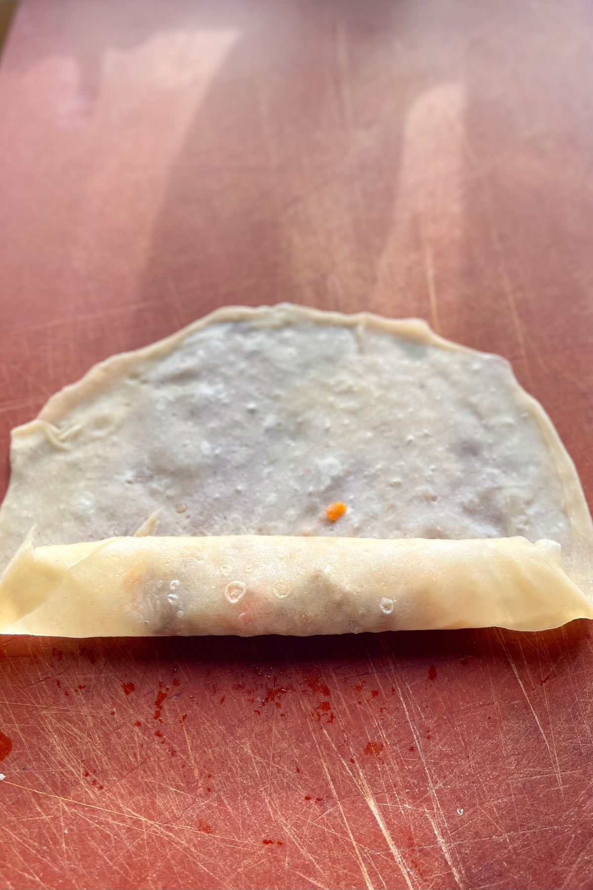 Rolling wrapper over filling.