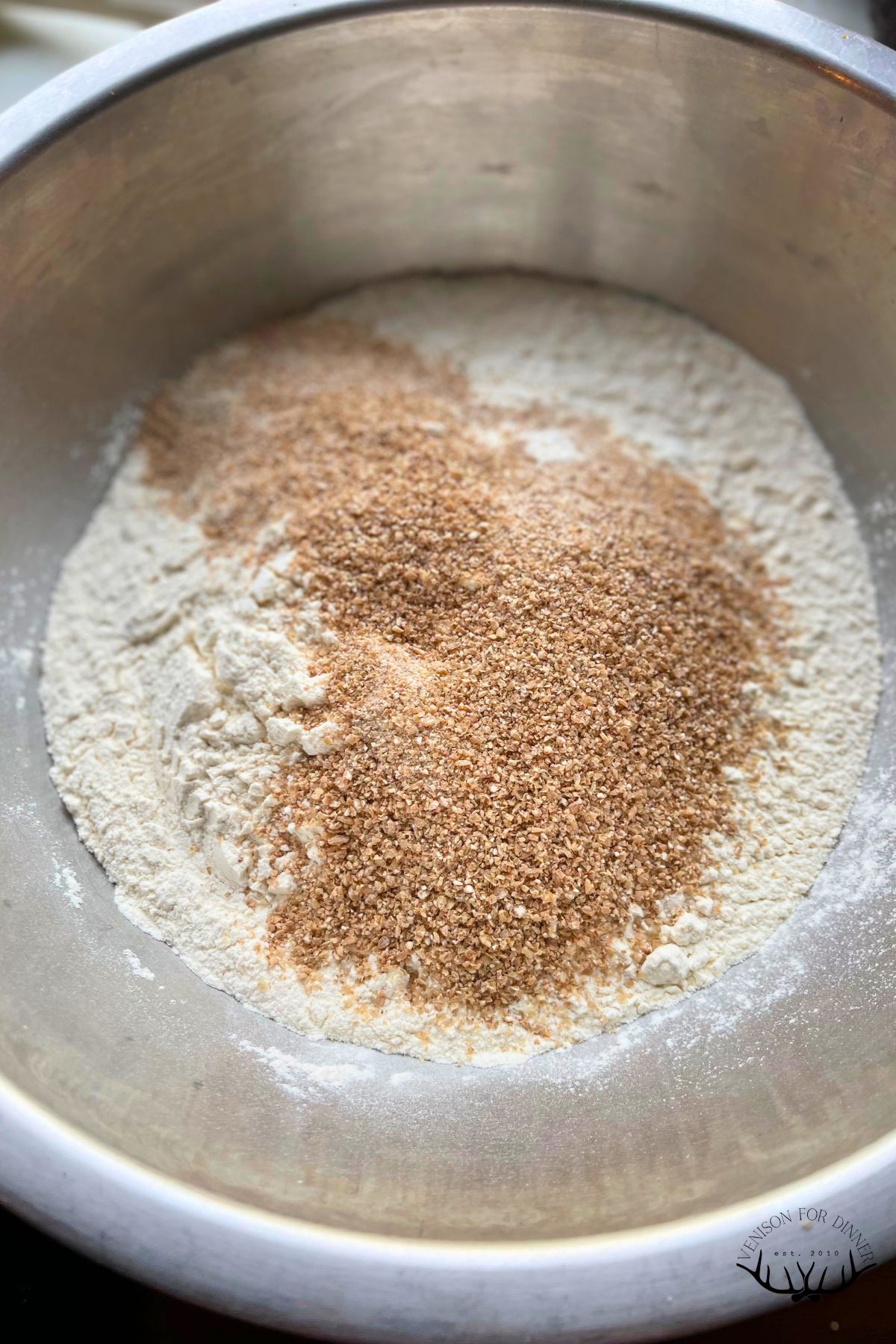 Dry ingredients for seedy sourdough in a mixing bowl.