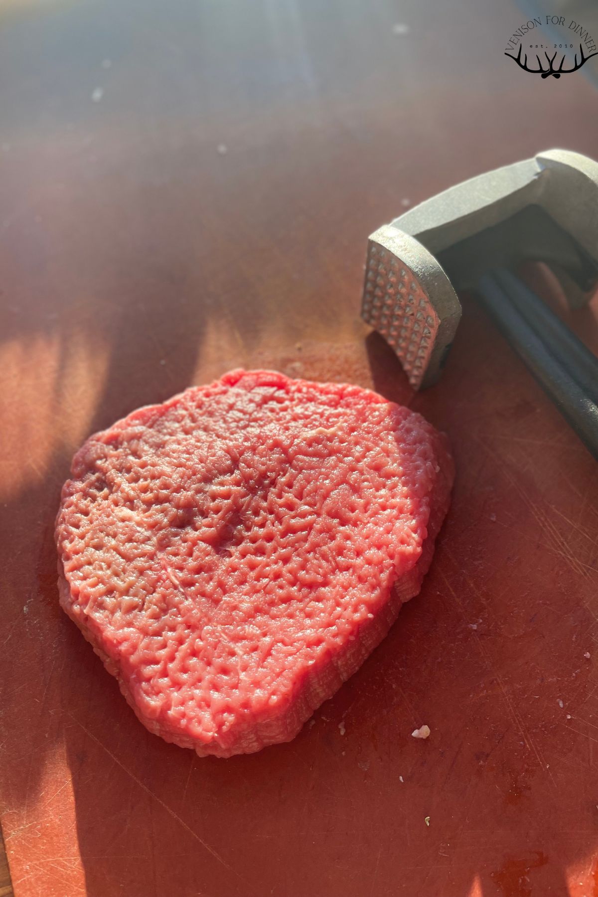 Meat mallet with venison cutlet.
