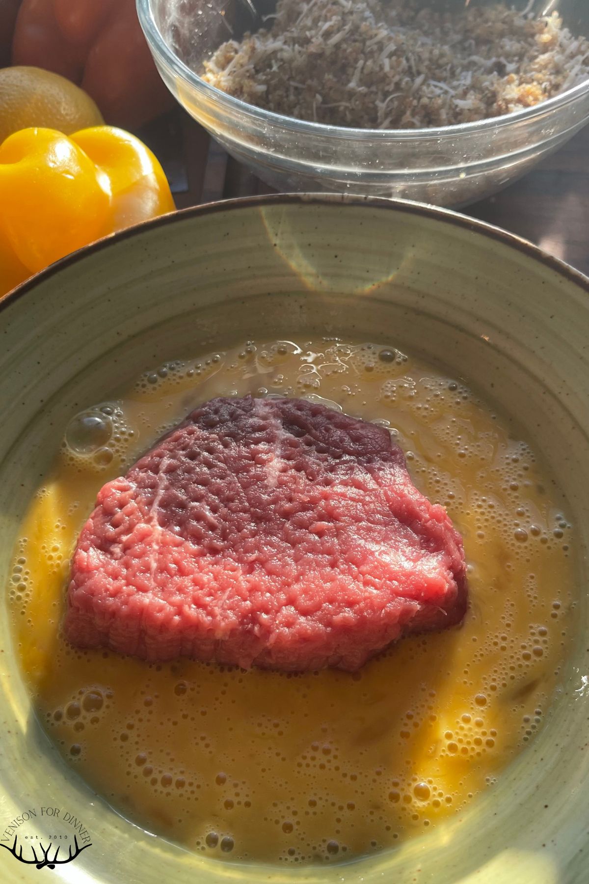 Venison cutlet in beaten eggs.