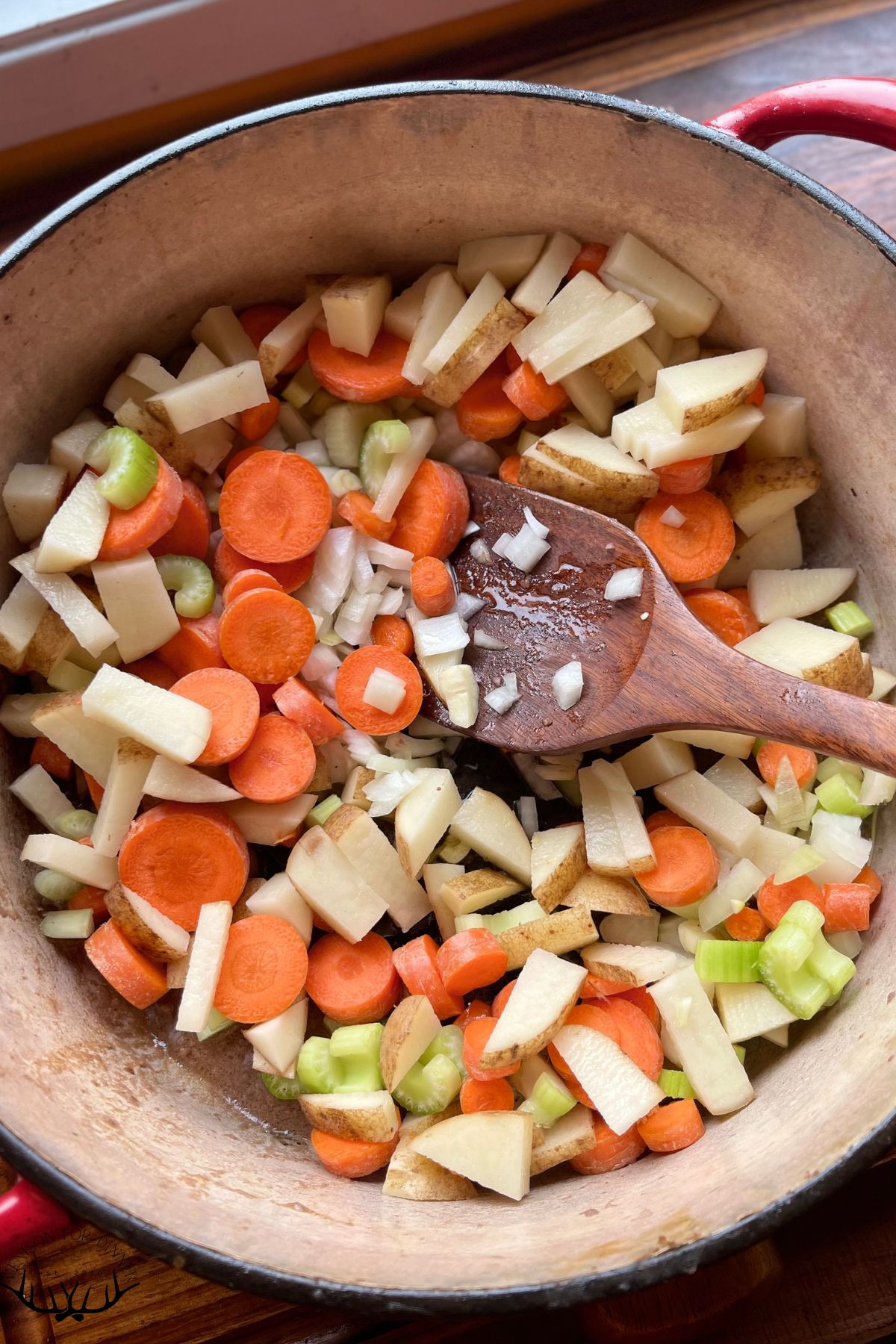 Chopped stew veggies in a dutch oven.