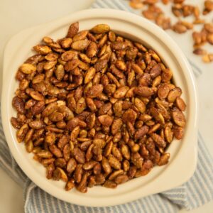 Top view of a bowl of candied pepitas.