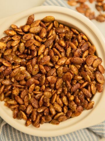 Top view of a bowl of candied pepitas.