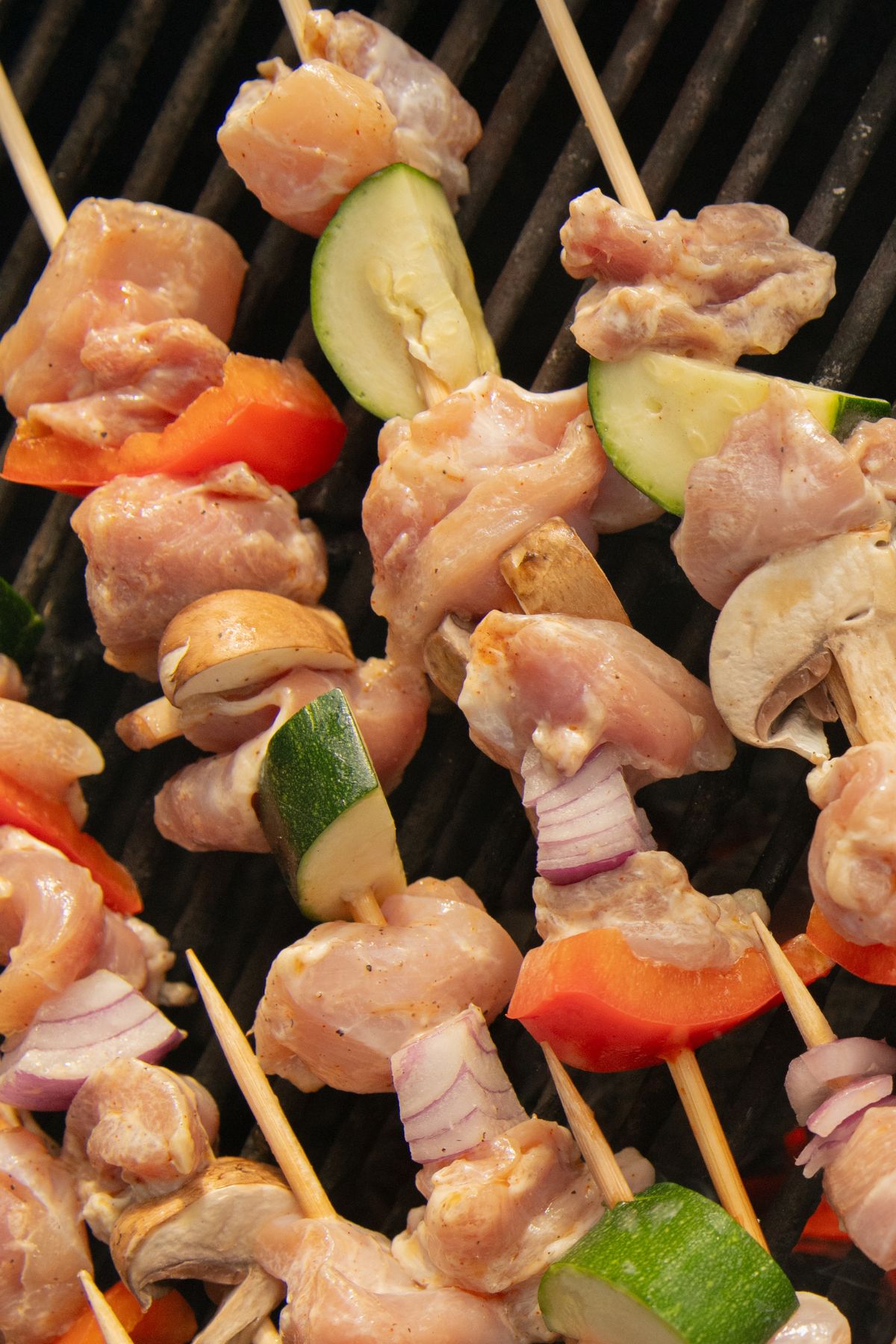 Mushroom, zucchini and chicken on bamboo skewers.