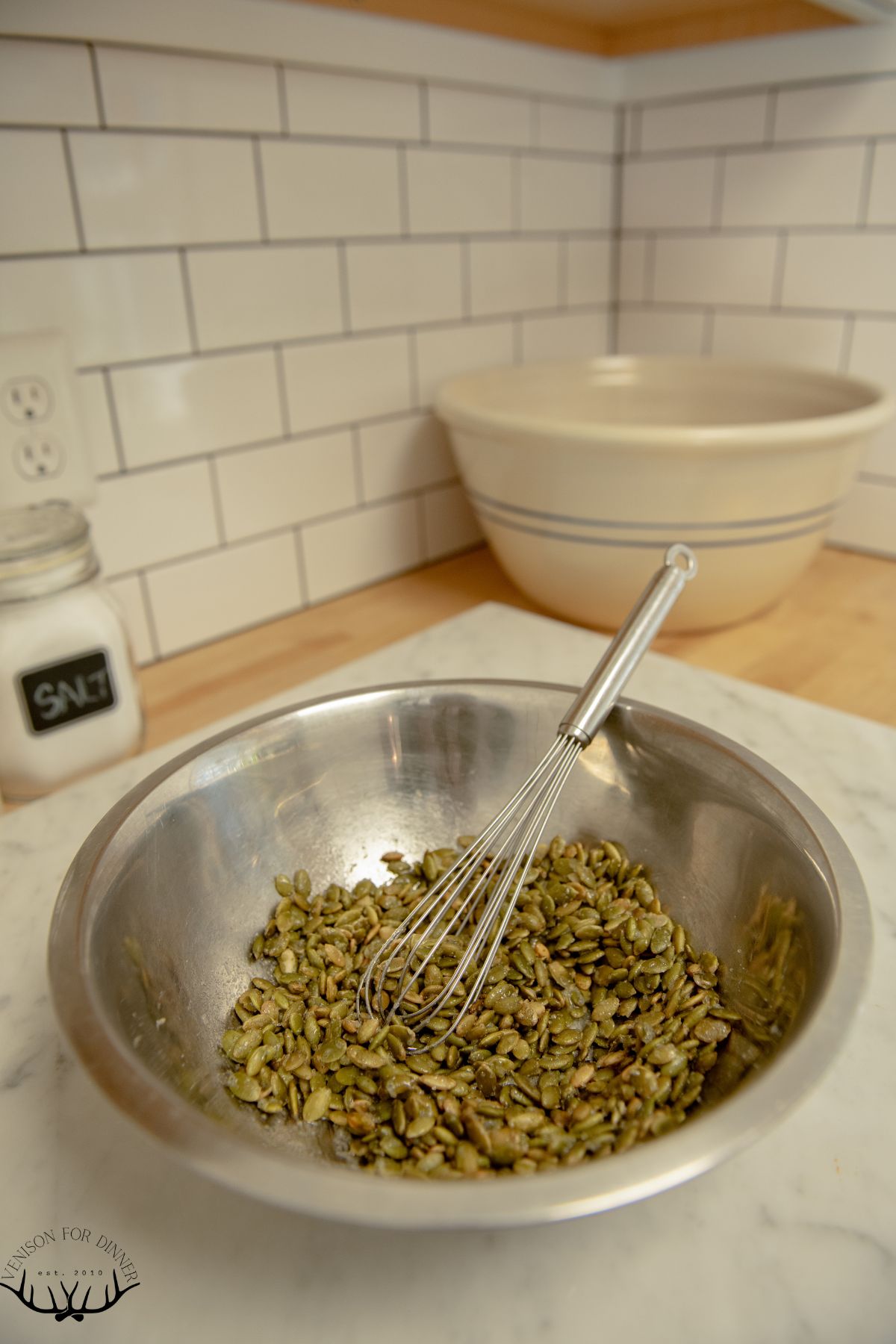 Stirring pepitas in egg whites.