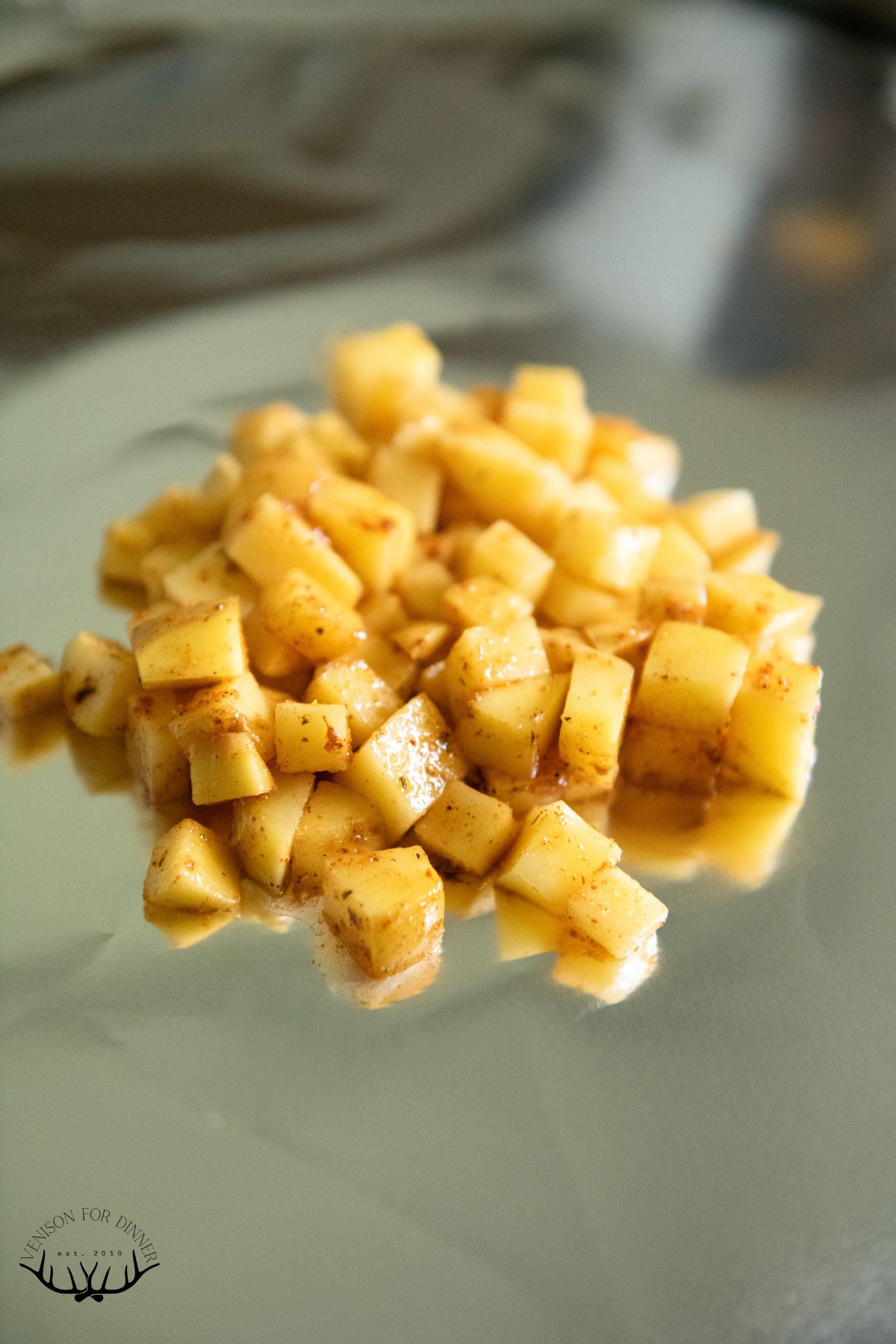 Diced, seasoned potatoes on a sheet of foil.