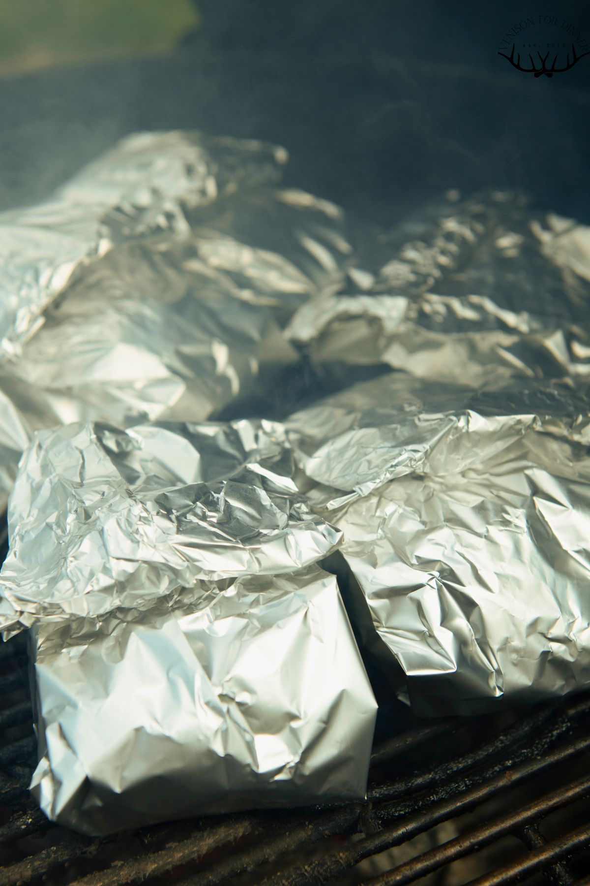 Chicken in foil packs on the grill.