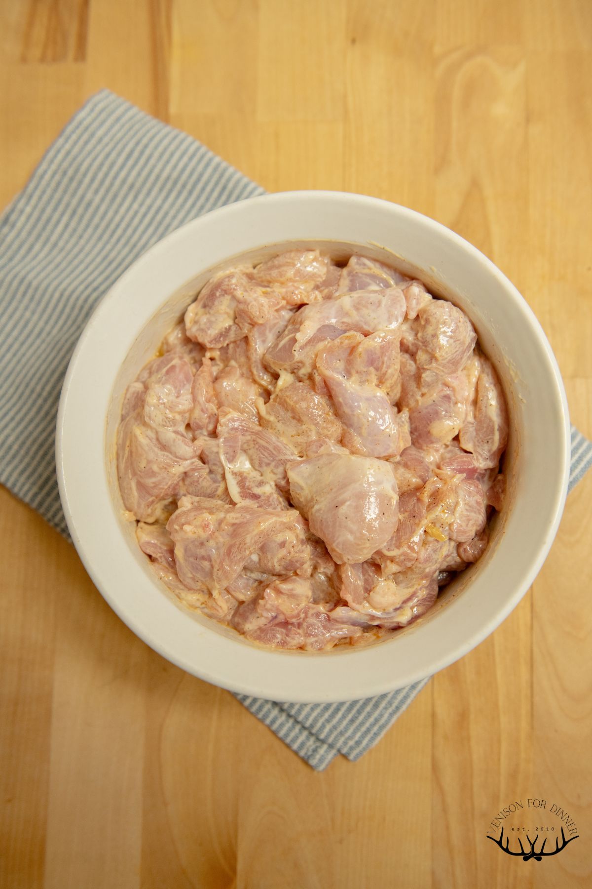 Diced chicken marinating in yogurt.