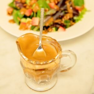 Spoon in a boat of balsamic dressing.